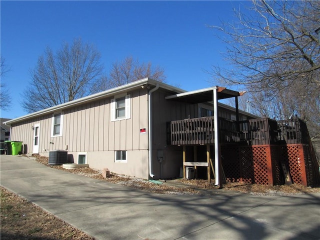 view of property exterior featuring stairway, board and batten siding, and a wooden deck