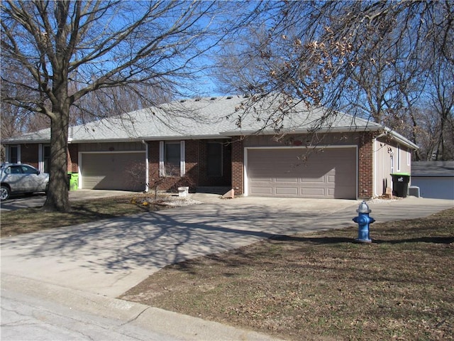 ranch-style house with a garage, brick siding, and driveway