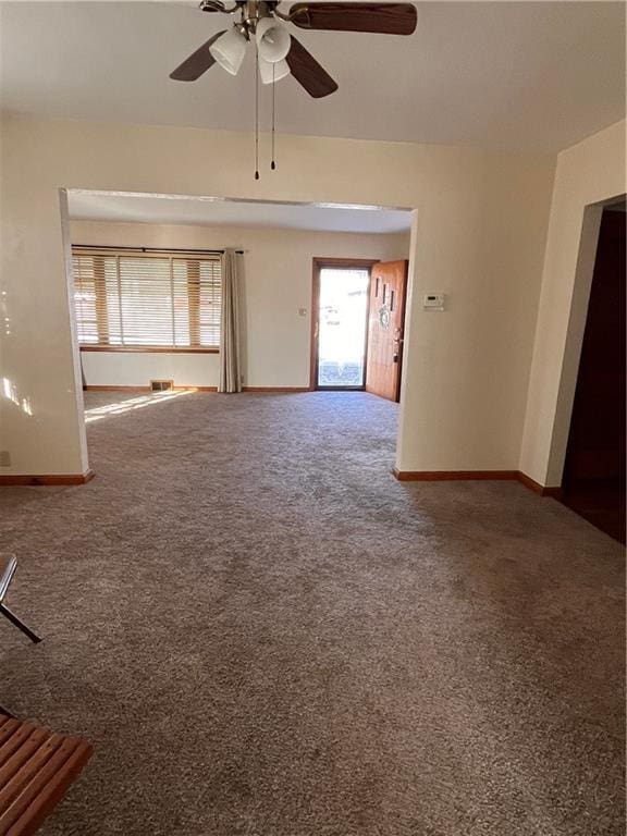 unfurnished living room with visible vents, baseboards, and carpet