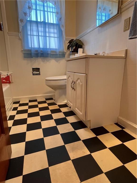 full bath with tile patterned floors, toilet, and vanity