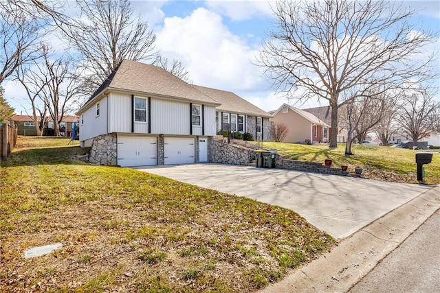 view of front of home with driveway, a front yard, and a garage