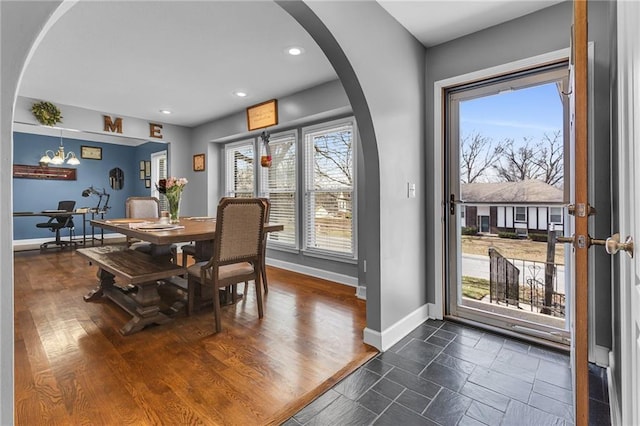 dining area with recessed lighting, baseboards, and arched walkways