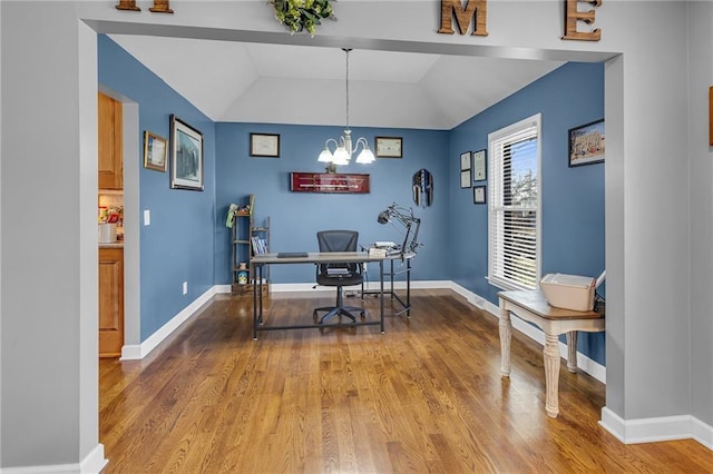 office space with baseboards, light wood-type flooring, and an inviting chandelier