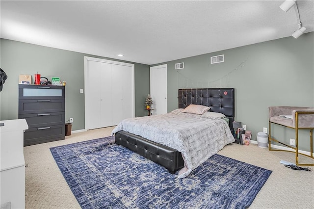 bedroom with visible vents, baseboards, and a textured ceiling