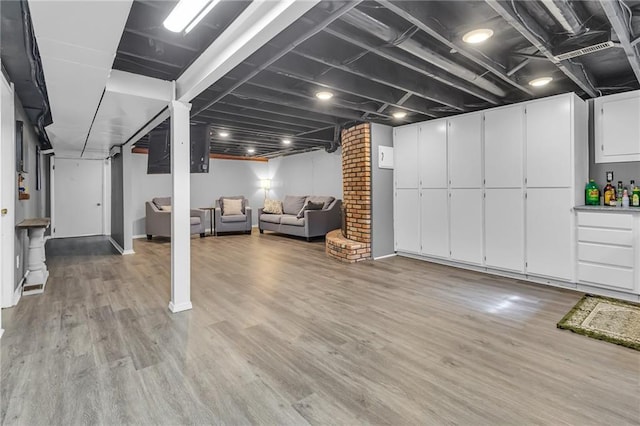 finished basement with light wood-type flooring