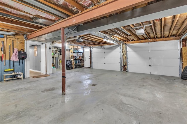 garage with a garage door opener and water heater