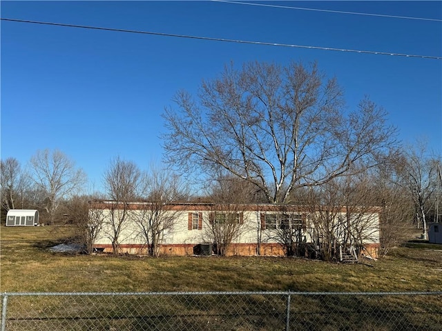 view of front of home with a front yard and fence