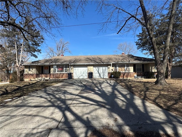 view of front of house with a garage, brick siding, covered porch, and driveway