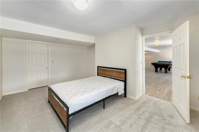 bedroom with pool table, a textured ceiling, baseboards, and carpet floors