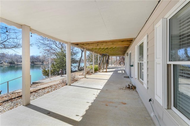 view of patio with stairway and a water view