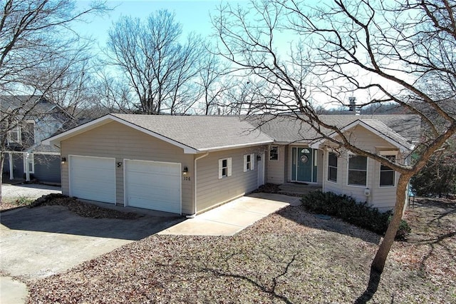 ranch-style home featuring an attached garage, driveway, and a shingled roof