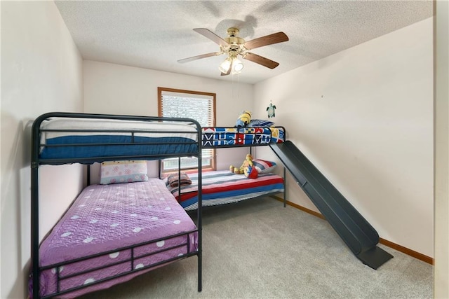 carpeted bedroom with baseboards, a textured ceiling, and a ceiling fan