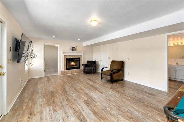 106 Timber Valley Dr, Linn Valley, KS 66040 - sitting room with light wood-style floors, baseboards, and a fireplace