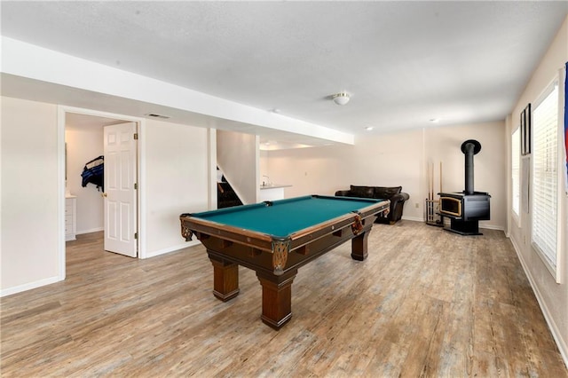 106 Timber Valley Dr, Linn Valley, KS 66040 - rec room featuring light wood-style floors, a wood stove, baseboards, and visible vents