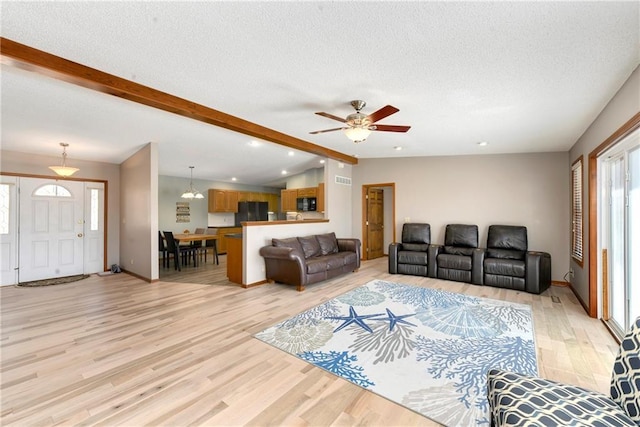 106 Timber Valley Dr, Linn Valley, KS 66040 - living area with light wood-type flooring, a ceiling fan, a textured ceiling, and vaulted ceiling with beams