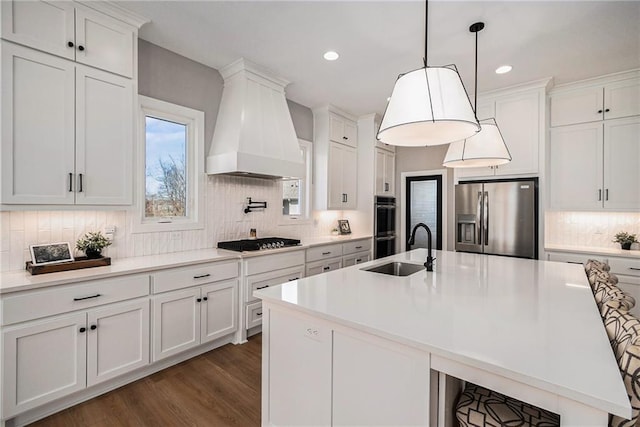 21143 W 189th Ct, Spring Hill, KS 66083 - kitchen with appliances with stainless steel finishes, premium range hood, backsplash, white cabinets, and light countertops