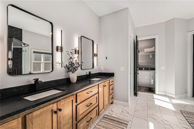 21143 W 189th Ct, Spring Hill, KS 66083 - full bathroom with separate washer and dryer, marble look tiles, double vanity, a shower, and a closet