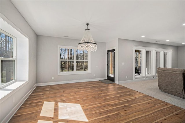 21143 W 189th Ct, Spring Hill, KS 66083 - spare room featuring plenty of natural light, wood finished floors, a chandelier, and recessed lighting
