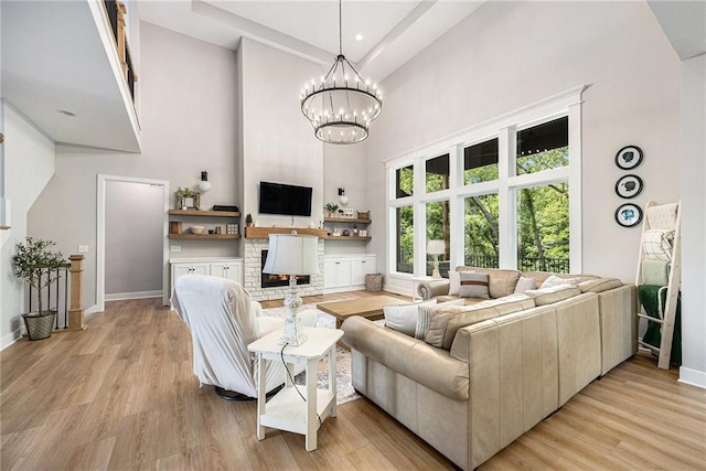 21143 W 189th Ct, Spring Hill, KS 66083 - living room with a high ceiling, light wood-style flooring, and a chandelier