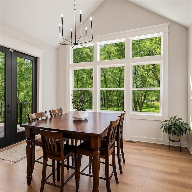 21143 W 189th Ct, Spring Hill, KS 66083 - dining area with vaulted ceiling, french doors, light wood-type flooring, and a chandelier