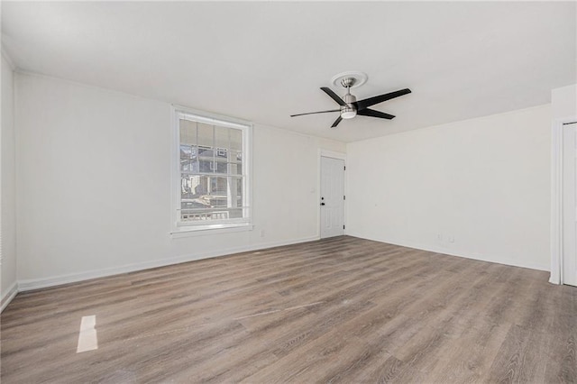 spare room with a ceiling fan and wood finished floors