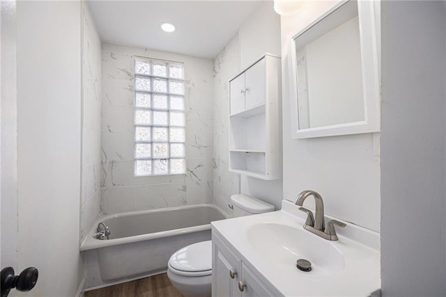 full bathroom featuring toilet, shower / washtub combination, wood finished floors, and vanity