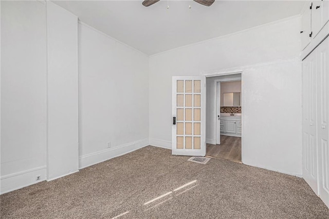 empty room with carpet flooring and ceiling fan