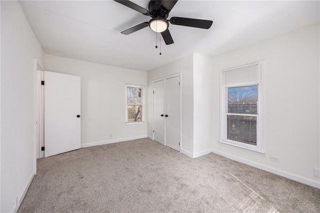 unfurnished bedroom with carpet, baseboards, and ceiling fan