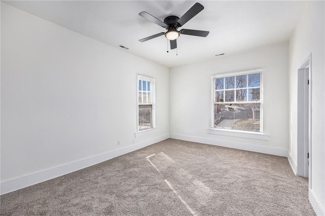 unfurnished room featuring visible vents, carpet flooring, and baseboards