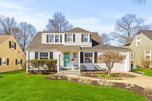 view of front of property featuring a front yard, concrete driveway, and an attached garage