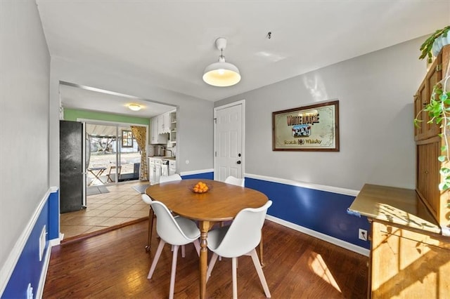 dining area featuring baseboards and wood finished floors