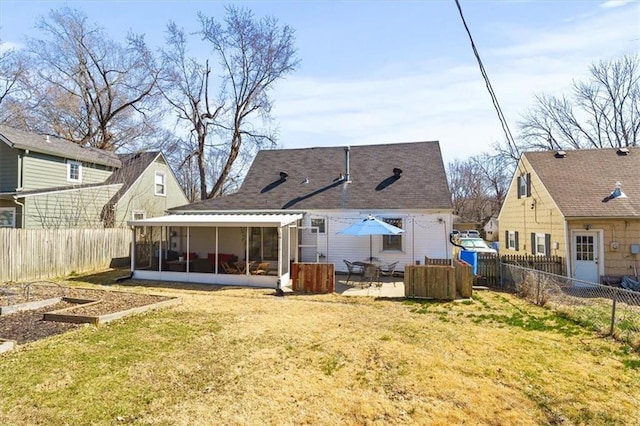 back of house featuring a yard, a patio, a fenced backyard, and a sunroom