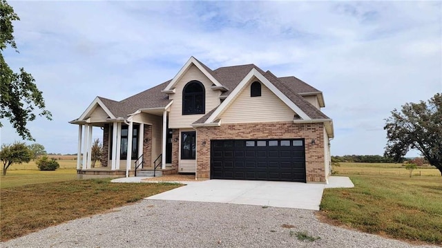 view of front of property with a front lawn, brick siding, driveway, and roof with shingles