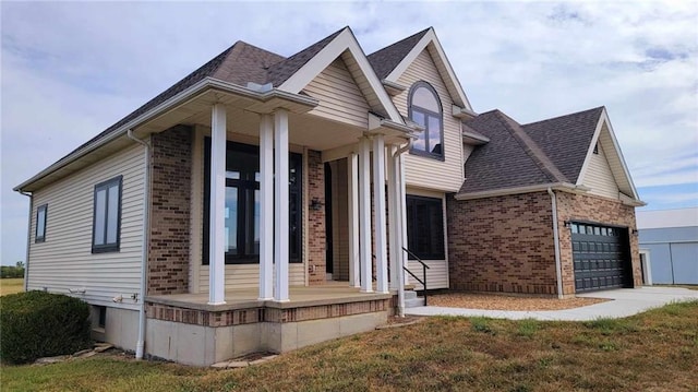 view of front of home with a garage, brick siding, roof with shingles, and driveway