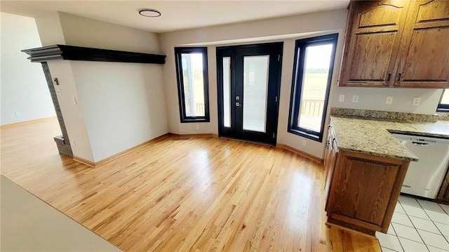 entrance foyer with baseboards and light wood finished floors