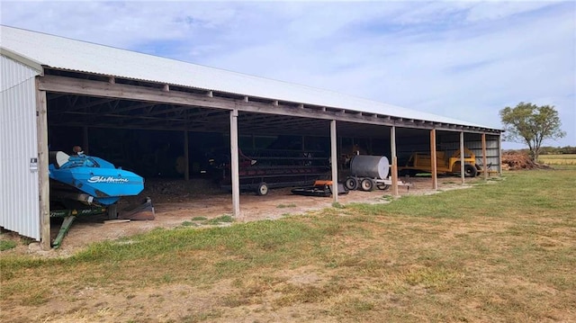 view of pole building with a carport, a yard, and driveway