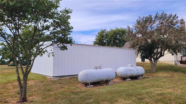 view of property exterior featuring an outbuilding and a lawn