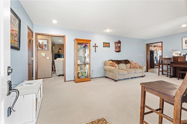 living area featuring recessed lighting and light carpet