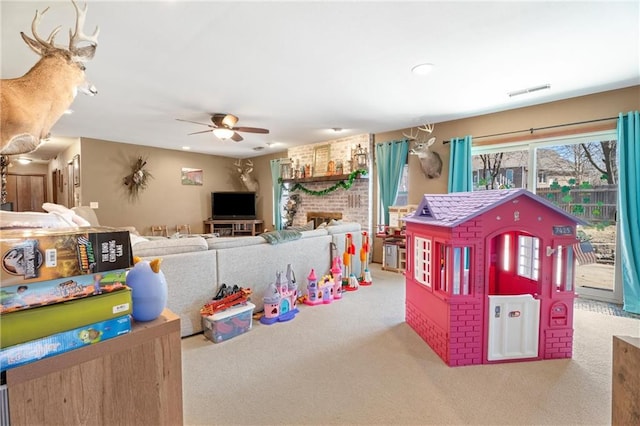 game room with visible vents, carpet floors, and ceiling fan