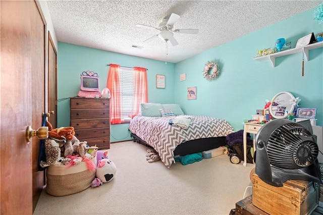 carpeted bedroom featuring visible vents, a textured ceiling, a closet, and ceiling fan