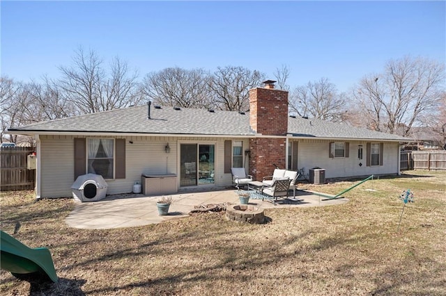 rear view of property with a patio, fence, a lawn, and a chimney
