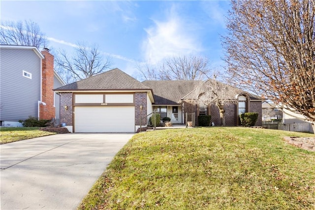 ranch-style home with brick siding, a garage, a front lawn, and driveway