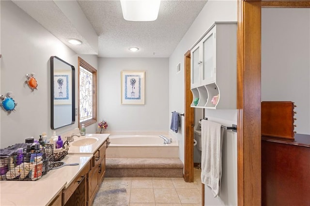 bathroom with vanity, a bath, tile patterned flooring, a textured ceiling, and toilet