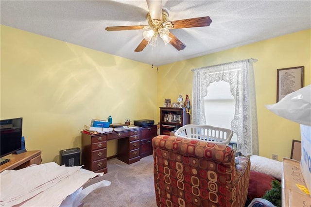 bedroom with light carpet, a textured ceiling, and a ceiling fan