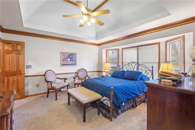 bedroom with light carpet, a raised ceiling, ornamental molding, a ceiling fan, and baseboards