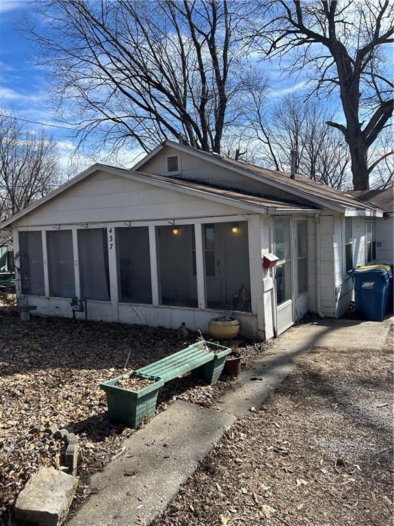 view of side of property with a sunroom