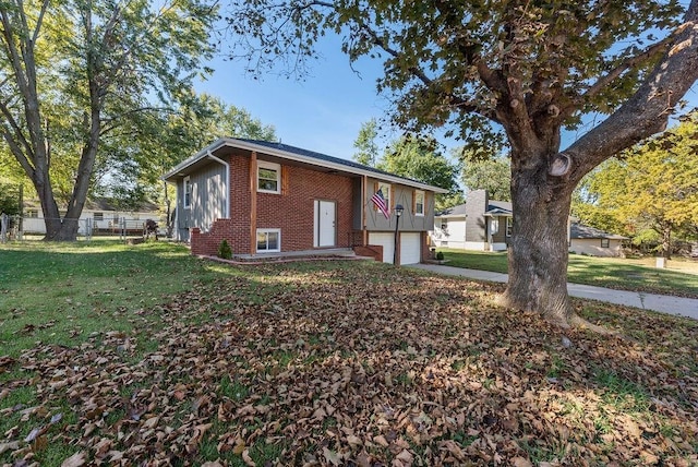 view of front of property with a front yard, fence, an attached garage, concrete driveway, and brick siding