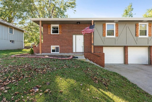 bi-level home with a garage, a front lawn, brick siding, and driveway