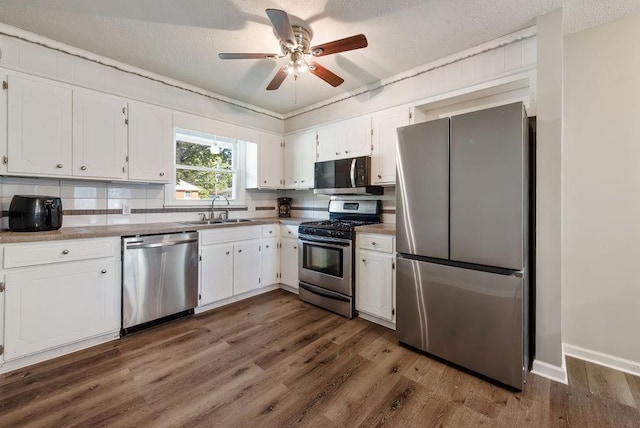 kitchen featuring a sink, white cabinetry, and stainless steel appliances