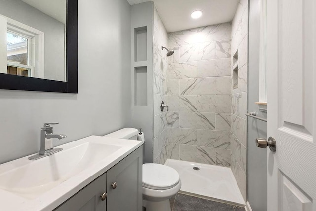 full bathroom featuring vanity, toilet, and a shower stall